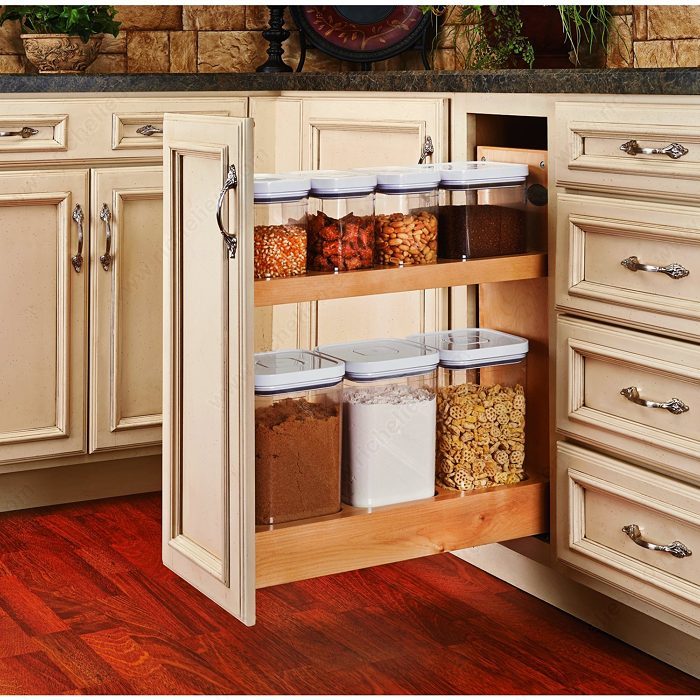 Small base cabinet with pullout attachment and bins of organized dry goods.