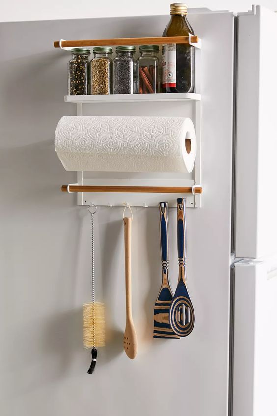Paper towel holder with spice rack shelf on top and utensil holders on the bottom.